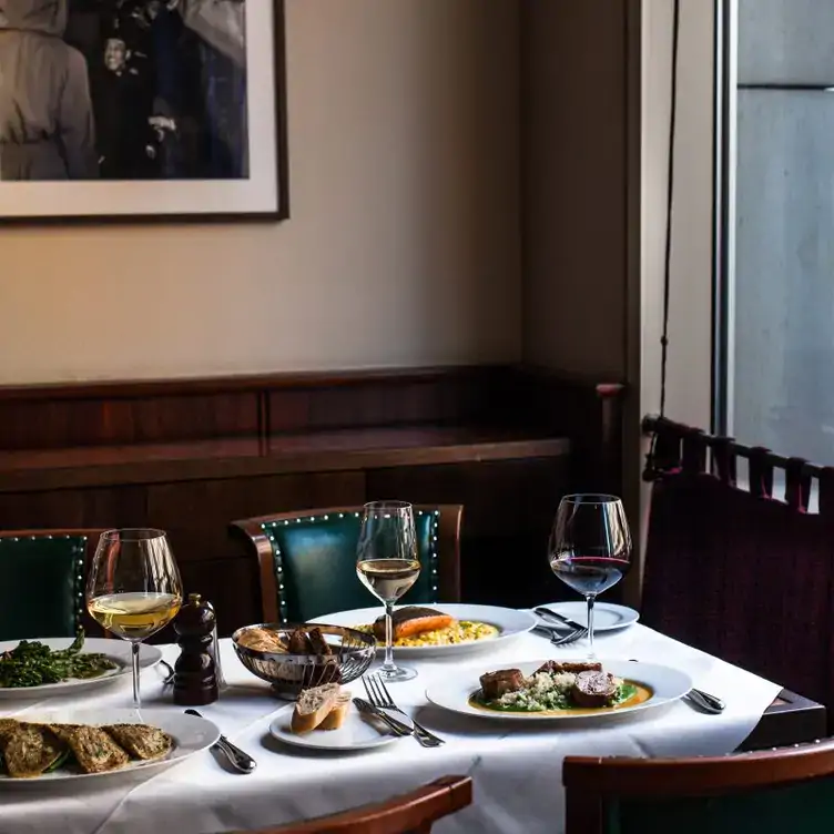 A set table with Austrian specialities and wine at Einstein Unter den Linden, one of the best restaurants in Berlin.